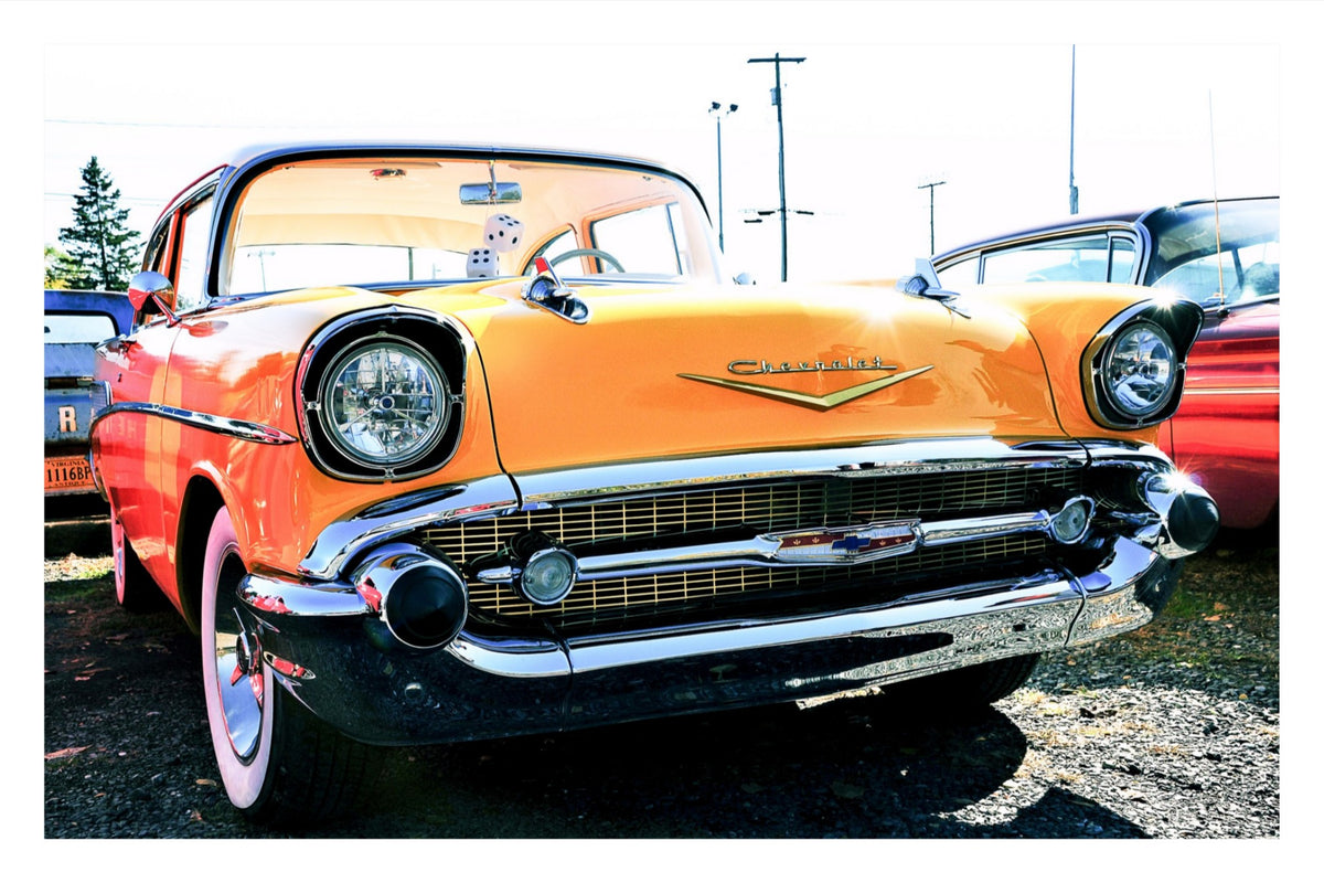 Yellow 57 — fine art print of a classic 1957 Chevrolet Bel Air in bright yellow, orange, and red, parked outdoors among vintage cars, by DC Ward